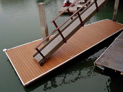 A wooden dock with stairs leading up to it in the water