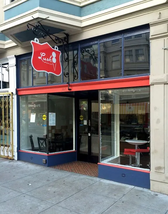 A store front with a red sign that says ' louis ' on it