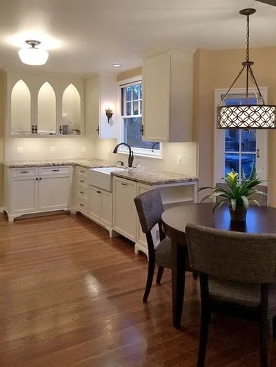 A kitchen with a table and chairs and a sink