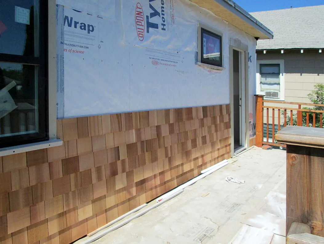 The side of a house is covered in styrofoam wrap