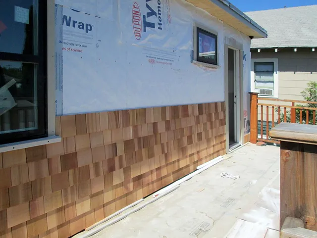 The side of a house is covered in styrofoam wrap