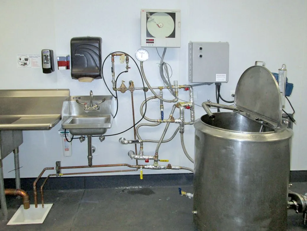 A kitchen with a sink and a clock on the wall