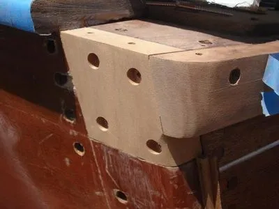 A piece of wood with holes in it is sitting on a table