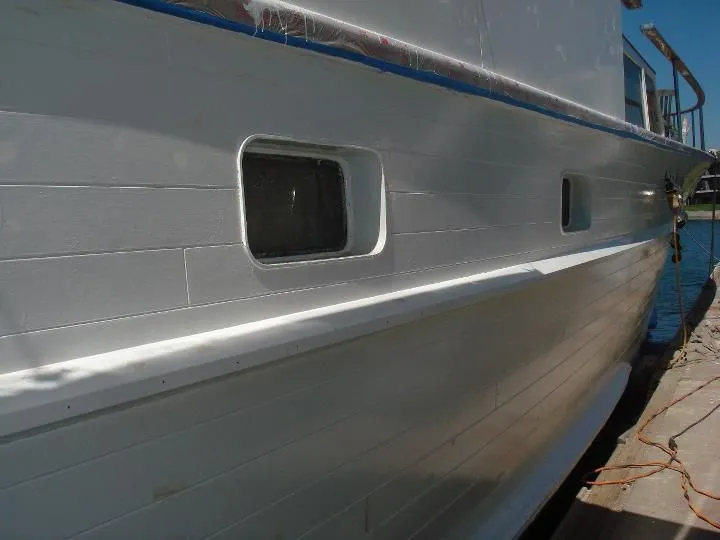 A large white boat is docked at a dock