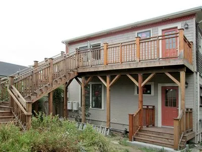 A house with a wooden deck and stairs leading up to it