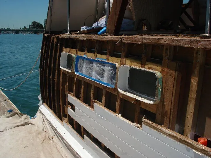A boat that is being remodeled with the word crest on it