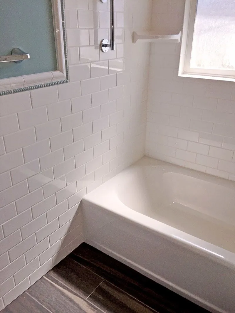 A bathroom with a bathtub and a shower.
