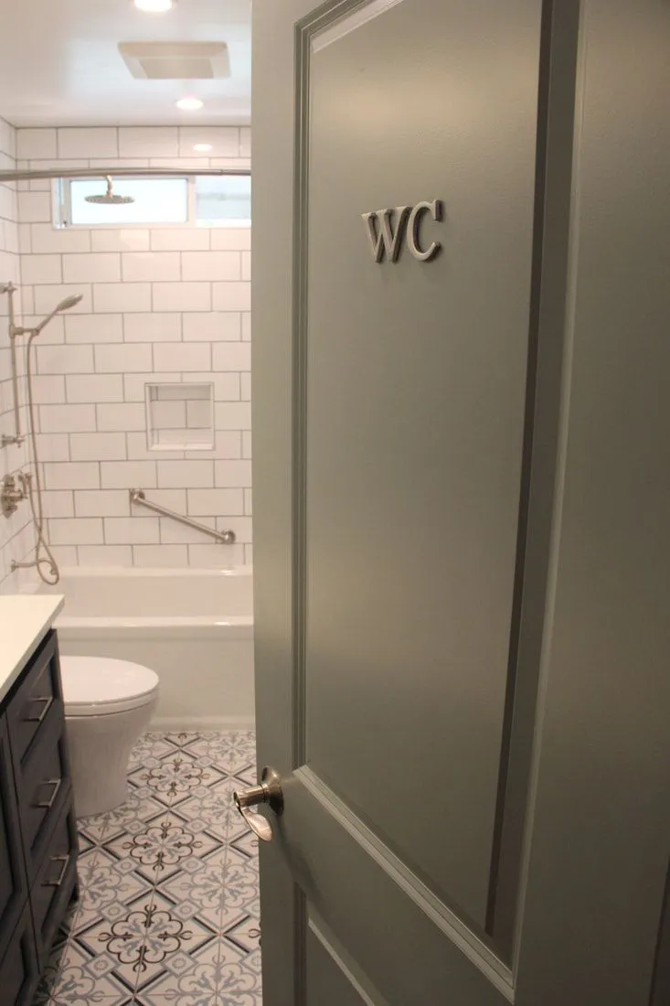A bathroom with a toilet , sink , bathtub and shower.