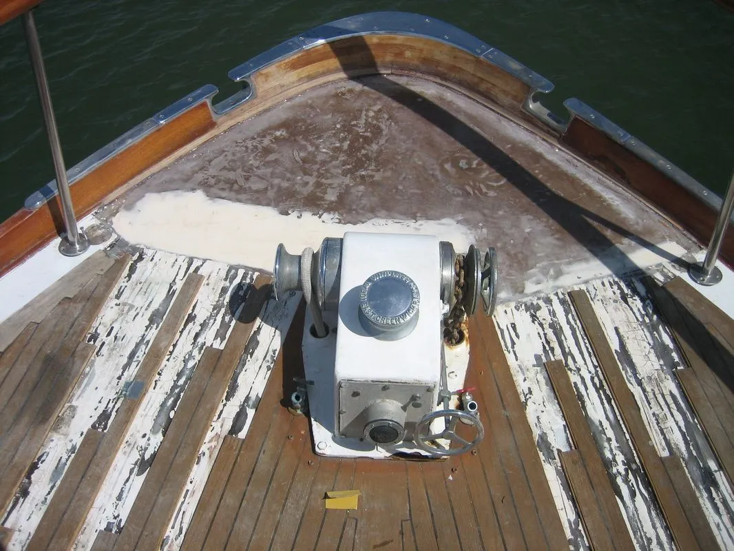 A wooden deck of a boat with a white box on it