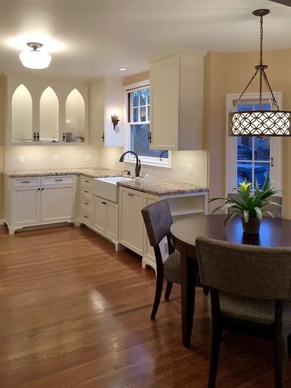 A kitchen with a table and chairs and a sink